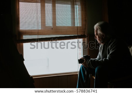 horizontal old man looking out the window
