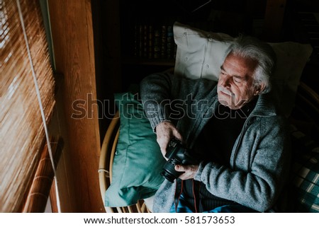 horizontal old man looking out the window