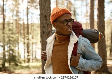 Horizontal Outdoor Image Of Man Hiker With Backpack On Shoulders Walking In Forest, Admiring Beauty Of Wild Nature, Having Rest On Weekend, Far Away From Big Noisy City, Looking Around With Curiosity