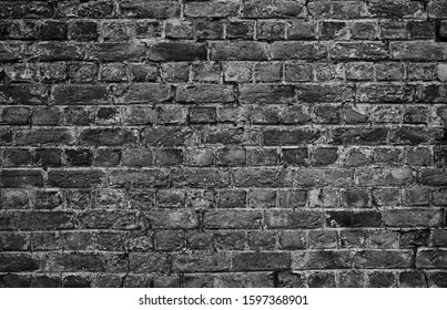 horizontal part of black painted brick wall - Shutterstock ID 1597368901
