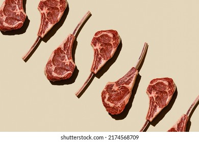 Horizontal Pattern Of Raw Fresh Meat Tomahawk Steak On Beige Background Flatlay Food