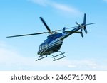 A horizontal photo of a Bell helicopter in flight