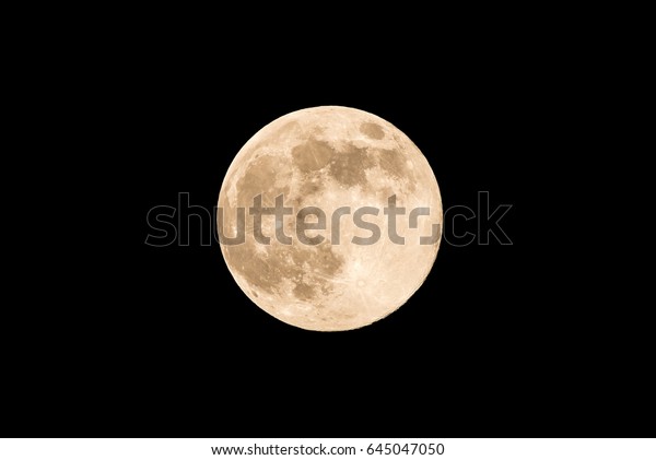 Horizontal photo of full moon. Moon with nice soft\
yellow color. Visible craters on the edge of space body. The bright\
and light areas on surface are clearly visible. Space around is\
black.