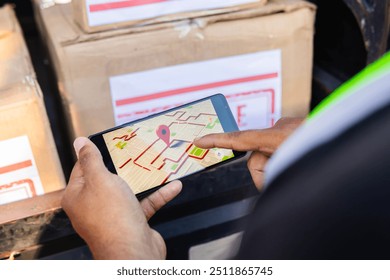 Horizontal photo of a Latino worker in a shipping company pointing to the GPS location on his phone to locate the next delivery in Colombia