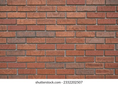 A horizontal photo of a multi-colored brick wall.