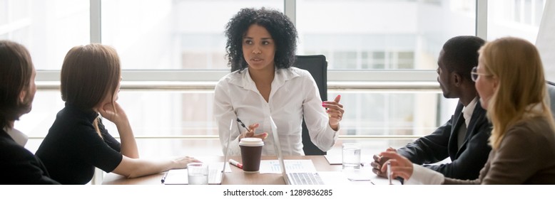 Horizontal Photo People Sitting At Boardroom African Business Woman Talking With Staff At Formal Meeting Briefing, Diverse Client Partners Listens Boss Ceo Team Leader Banner For Website Header Design