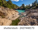 Horizontal photo of the source of Fuente Caputa, between rocks, in the town of Mula, Region of Murcia, Spain, between rocks and on a sunny day