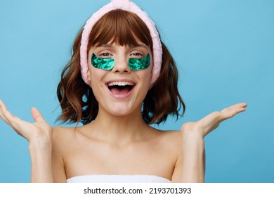 Horizontal Photo, A Woman With Ideal Smooth Skin On A Blue Background With Luxurious Dark Hair And Bright Green Luxurious Patches Is Very Extremely Surprised. Fashion Industry