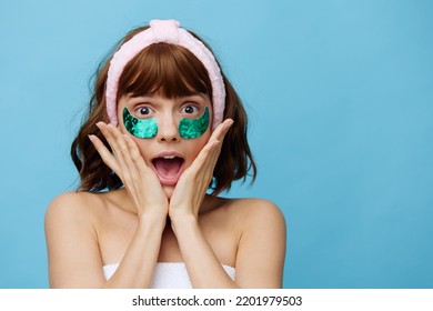 Horizontal Photo, A Woman With Ideal Smooth Skin On A Blue Background With Luxurious Dark Hair And Bright Green Luxurious Patches Is Very Extremely Surprised. Fashion Industry