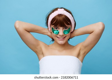 Horizontal Photo, A Woman With Idyllic Smooth Skin On A Blue Background With Luxurious Dark Hair And Bright Green Luxurious Patches Holds On To Her Hair And Is Very Happy