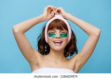 Horizontal Photo, A Woman With Idyllic Smooth Skin On A Blue Background With Luxurious Dark Hair And Bright Green Luxurious Patches Holds On To Her Hair And Is Very Happy