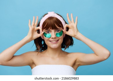 Horizontal Photo, A Woman With Idyllic Smooth Skin On A Blue Background With Luxurious Dark Hair And Bright Green Luxurious Patches Holds On To Her Hair And Is Very Happy