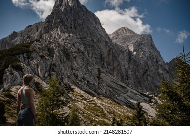Horizontal photo of young sporty woman enjoying beautiful view of Julian Alps during her late summer hike in Slovenia.