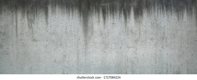 Horizontal picture of old and stained concrete wall with dripped water signs, suitable for backgrounds
