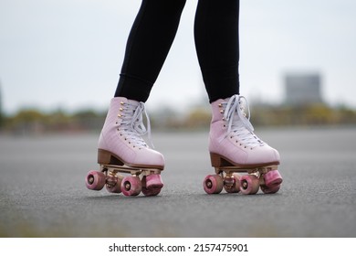 Horizontal Picture Of Person Rollerskating, Close Up Of Pink Vintage Quad Roller Skates. Concept: Leisure Activities. Movement, Summer, Sports, Vacations, Free Time, Outdoor Activities. 