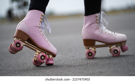 Horizontal Picture Of Person Rollerskating, Close Up Of Pink Vintage Quad Roller Skates. Concept: Leisure Activities. Movement, Summer, Sports, Vacations, Free Time, Outdoor Activities. 