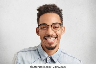 Horizontal Portrait Of Happy Male Enterpreneur Being Glad To Succeed In Marketing Development, Expresses Positive Emotions And Feelings, Isolated Over White Studio Background. Facial Expressions