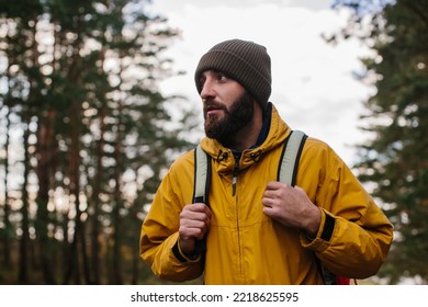 Horizontal portrait of hiker young male hiking in mountains with travel backpack. Traveler man with beard trekking and mountaineering. Travel, people, healthy lifestyle concept - Powered by Shutterstock