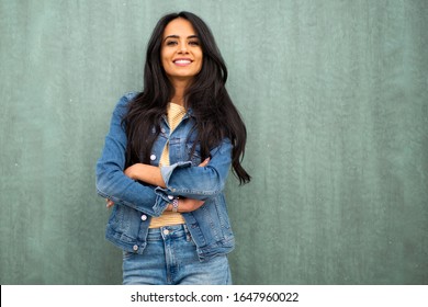 Horizontal Portrait Smiling Young Latin Woman Leaning Against Green Wall 