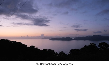 horizontal sea view mountains and purple sky after sunset - Powered by Shutterstock