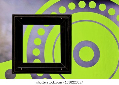 A horizontal shot of a background with beautiful green and grey circle patters and a black square frame - Powered by Shutterstock