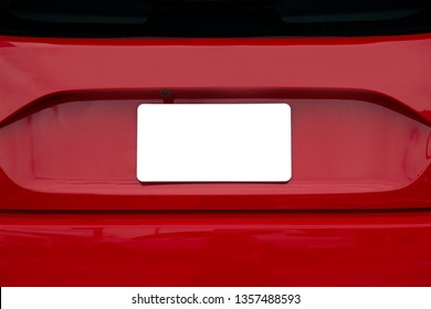 Horizontal shot of a blank white license plate on the back of red car.