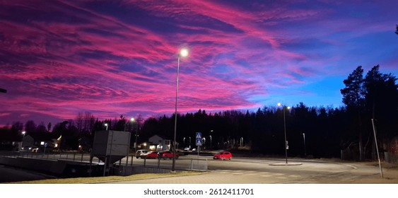A horizontal shot capturing a dramatic twilight sky over a street scene
