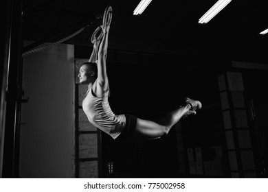 Horizontal shot a crossfit and fitness female athlete working out on gymnastic rings grip arms body healthy confident determined motivation improvement fitness athlete women beauty concept, crossfit - Powered by Shutterstock