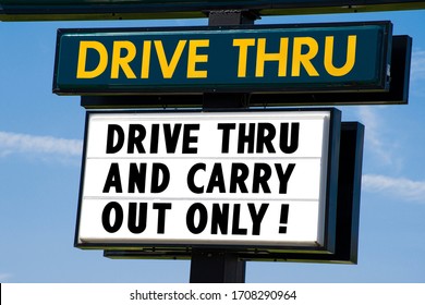 Horizontal Shot Of A Drive Thru Sign That Says Drive Thru And Carry Out Only!  Blue Sky Behind It.