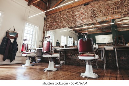 Horizontal shot of empty chairs in retro styled barbershop. Hair salon interior.
