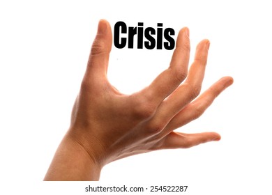 Horizontal shot of a hand holding the word "Crisis" between two fingers, isolated on white.