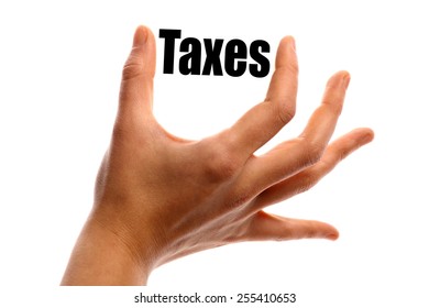 Horizontal shot of a hand holding the word "Taxes" between two fingers, isolated on white.