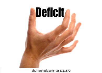 Horizontal shot of a hand holding the word "Deficit" between two fingers, isolated on white.