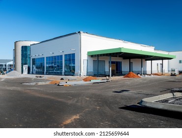 Horizontal Shot Of A Large Retail Big Box Store Under Construction Under A Blue Sky.