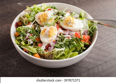 Horizontal Shot Of Large White Bowl Of Deviled Egg Salad On Dark Wooden Background