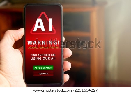 Horizontal shot of male hand holding mobile phone screen with warning about AI replacing job and telling the man to find another job using AI. Concept of AI replacing jobs, social issue.