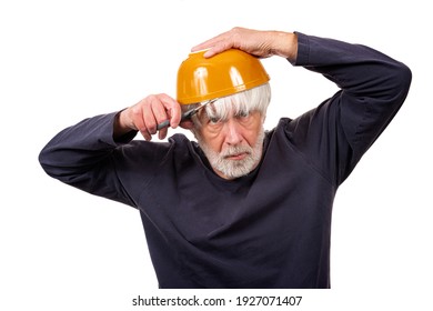 Horizontal Shot Of An Old Man Giving Himself A Haircut Using A Yellow Bowl On His Head During The Pandemic.  White Background.