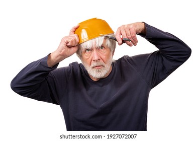 Horizontal Shot Of An Old Man Giving Himself A Haircut Using A Yellow Bowl On His Head During The Pandemic.  White Background.