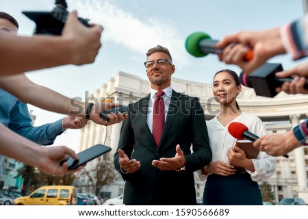 Similar – Image, Stock Photo Journalist holding microphone making media interview