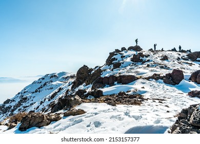 Horizontal shot of the top of snow-capped Provincia mountain with climbers, Chile