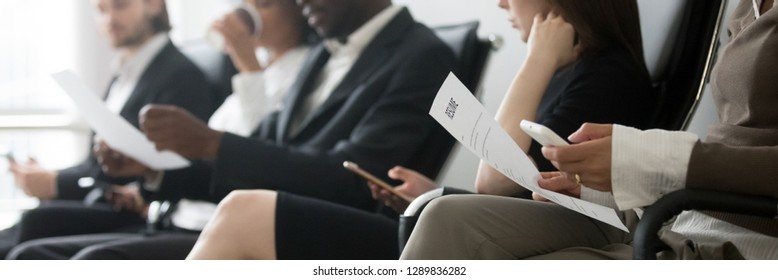 Horizontal side photo multinational applicants businesspeople sitting in queue waiting job interview holding resume papers using mobile phones, hr employment concept, banner for website header design - Shutterstock ID 1289836282