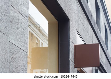 Horizontal side view of empty blank signage of store clothes shop on business skyscraper with modern architecture and glass windows 