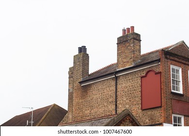 Horizontal side view of empty square signage on a brick decorated building with classical architecture