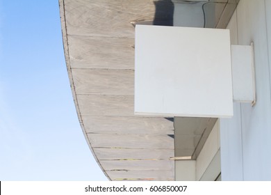 horizontal side view of empty white square signage on the exterior of a building