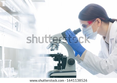 Similar – Image, Stock Photo Unrecognizable female scientist analyzing a blue glitter sample over petri dish on laboratory