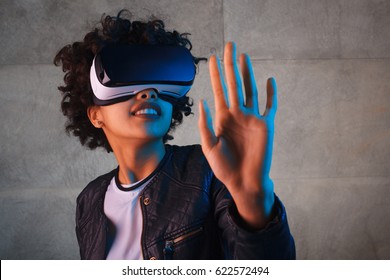 Horizontal Studio Shot Of Woman With VR Headset Touching The Air.