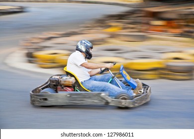 Horizontal Take Of An Asian Driver And Go Kart As They Zoom Past On A Public Race Track In Goa India