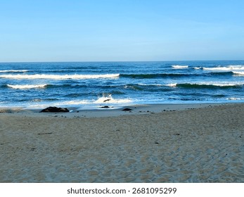 Horizontal view of Atlantic waves rolling onto sandy beach on the Camino Portugués da Costa 