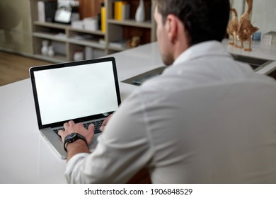 Horizontal View. Back View Of Handsome Mature Man In Casual Clothes Using A Laptop While Sitting At The Table In Office.