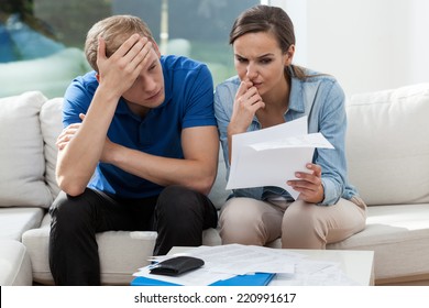 Horizontal View Of Couple Analyzing Family Bills